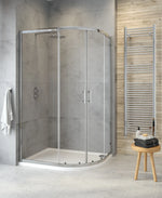 A modern two door offset quadrant shower enclosure with clear glass and chrome handles, installed in a bathroom setting.