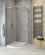 A quadrant shower enclosure with a single door, chrome handles, and clear glass panels, installed in a bathroom setting.