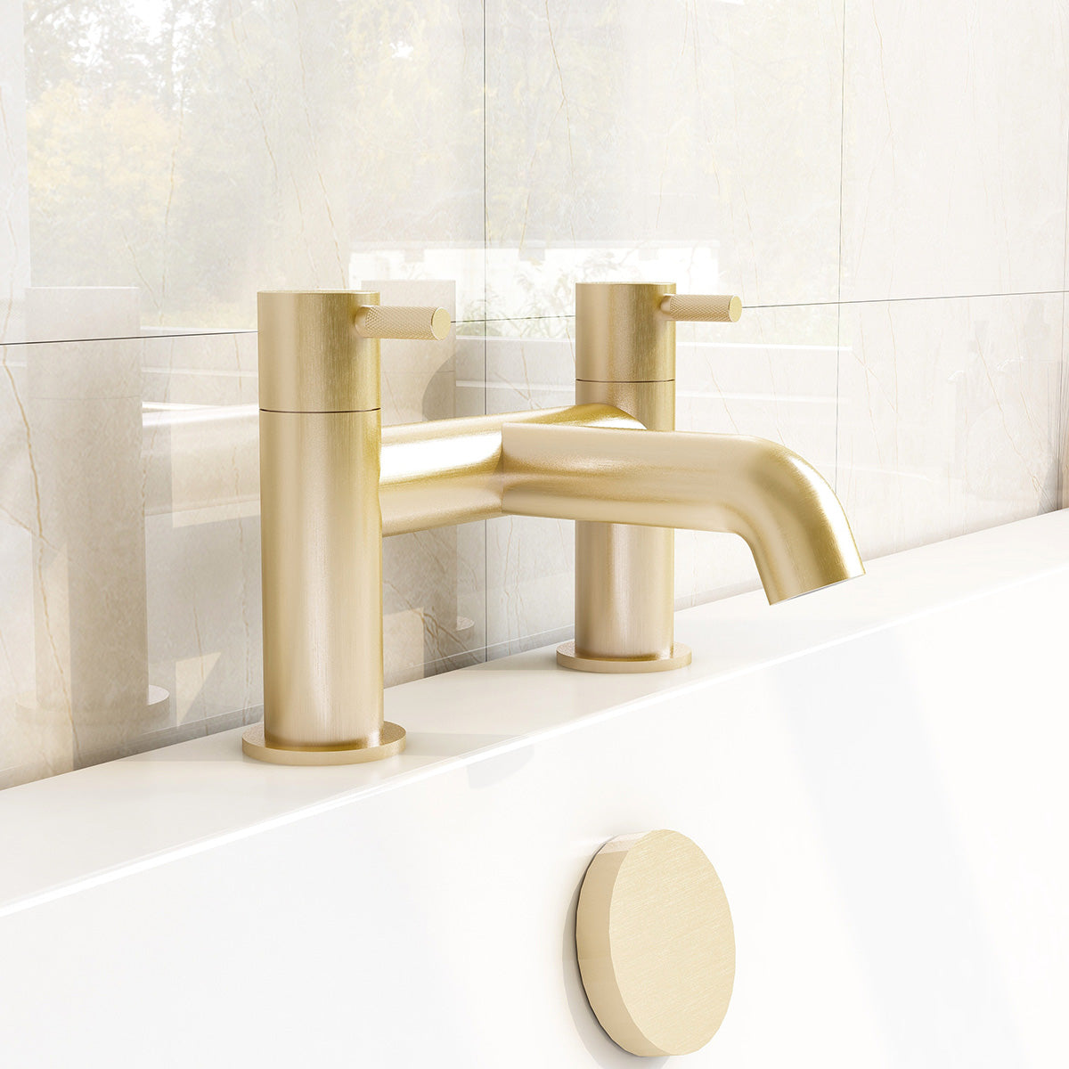 A brass-plated bath filler with a sleek, modern design, mounted on a white marble bathroom wall.